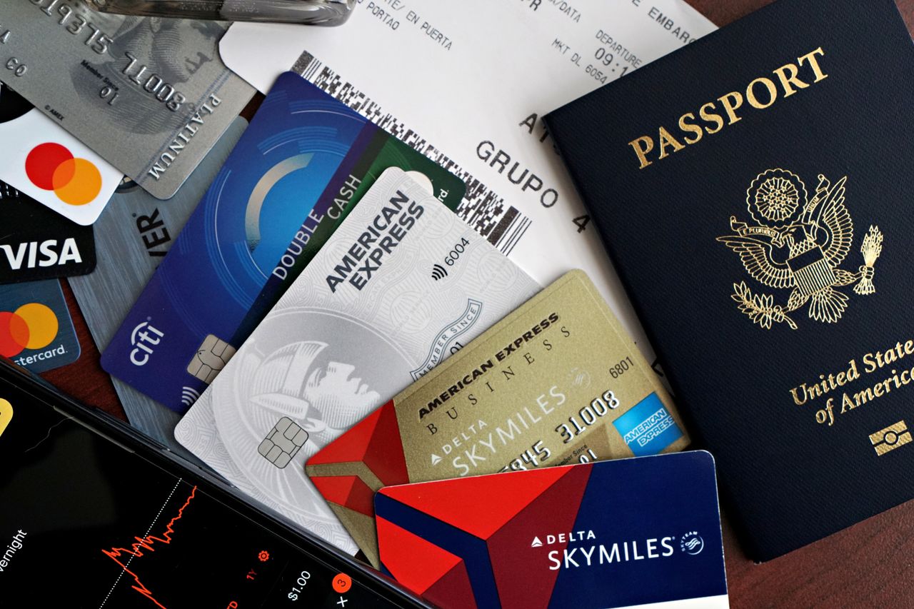 services-03 A collection of travel essentials including a passport, credit cards, and a boarding pass. Ideal for travel and finance concepts.